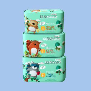 Stack of Kiddicare diaper packs on a teal background